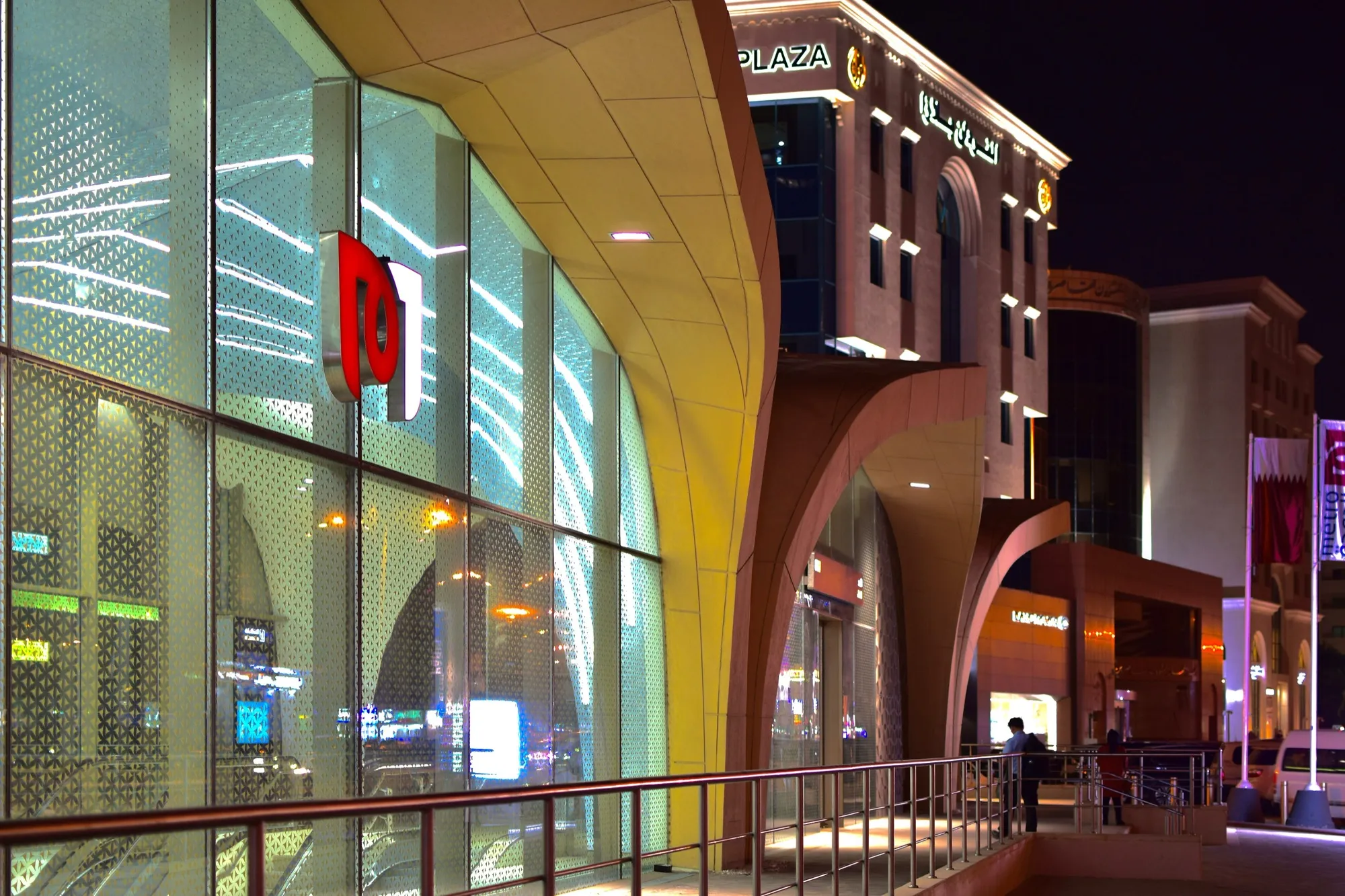 Sculptural façade and glazing of Al Sadd Metro Station at night on the Doha Gold Line